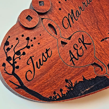 Detailed macro shot of a “Just Married” engraved heart ring box made from high-quality wood. The product showcases a laser-cut custom monogram with initials and a beautiful floral silhouette. Ideal as a wedding ring holder, personalized proposal box, romantic engagement keepsake, or anniversary wood box for couples. One of the best custom wooden ring boxes for handmade gifts.