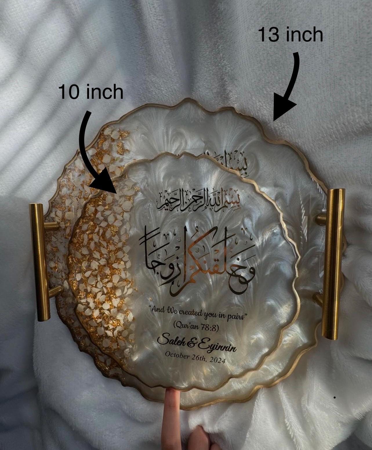 Top view of personalized engagement tray with clear handles, Arabic calligraphy, floral accents, and white swirl background