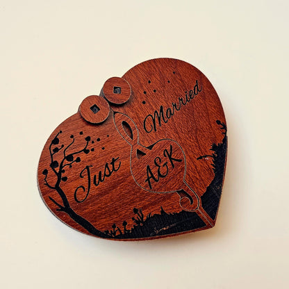 A collage of angles showing the personalized wooden heart ring box in both open and closed positions. Custom engraved with initials, it features a romantic “Just Married” message and two slots to hold wedding or engagement rings. This custom couple’s gift is ideal for ring bearer duties, wedding ceremonies, proposal events, anniversary gifting, or use as a love story keepsake box. Also known as a custom rustic jewelry box or engraved wedding accessory.
