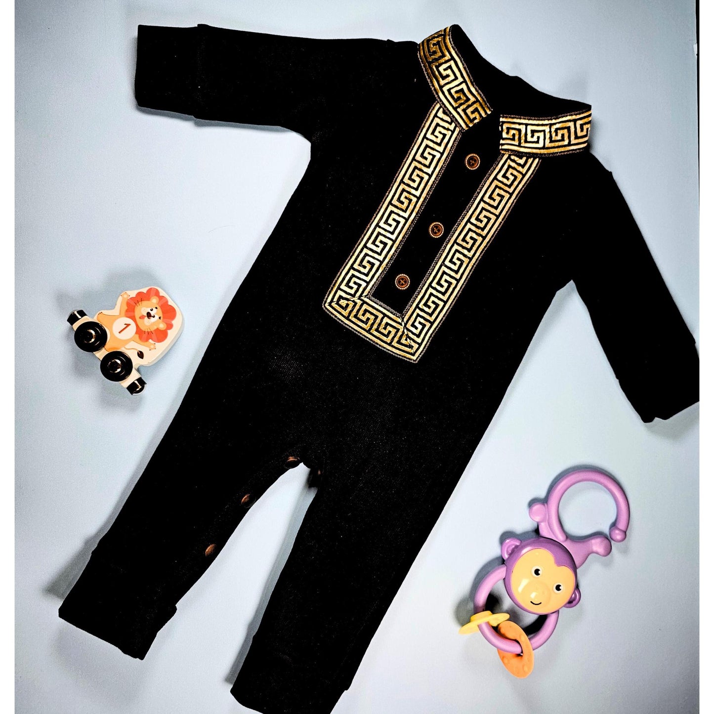 Black baby romper with Islamic embroidery and engraved leather name tag “Ahmed”
