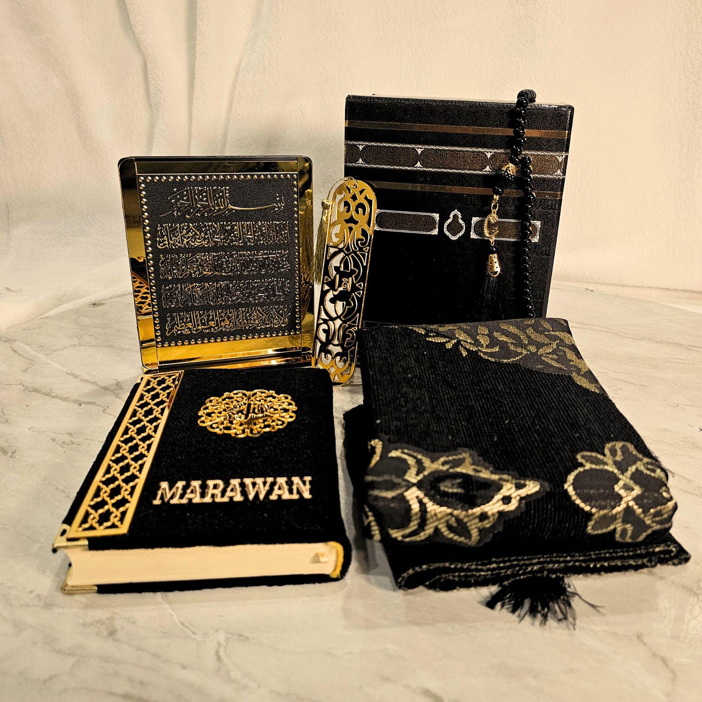 Personalized Quran with elegant cover design, placed inside Kaaba-inspired gift box