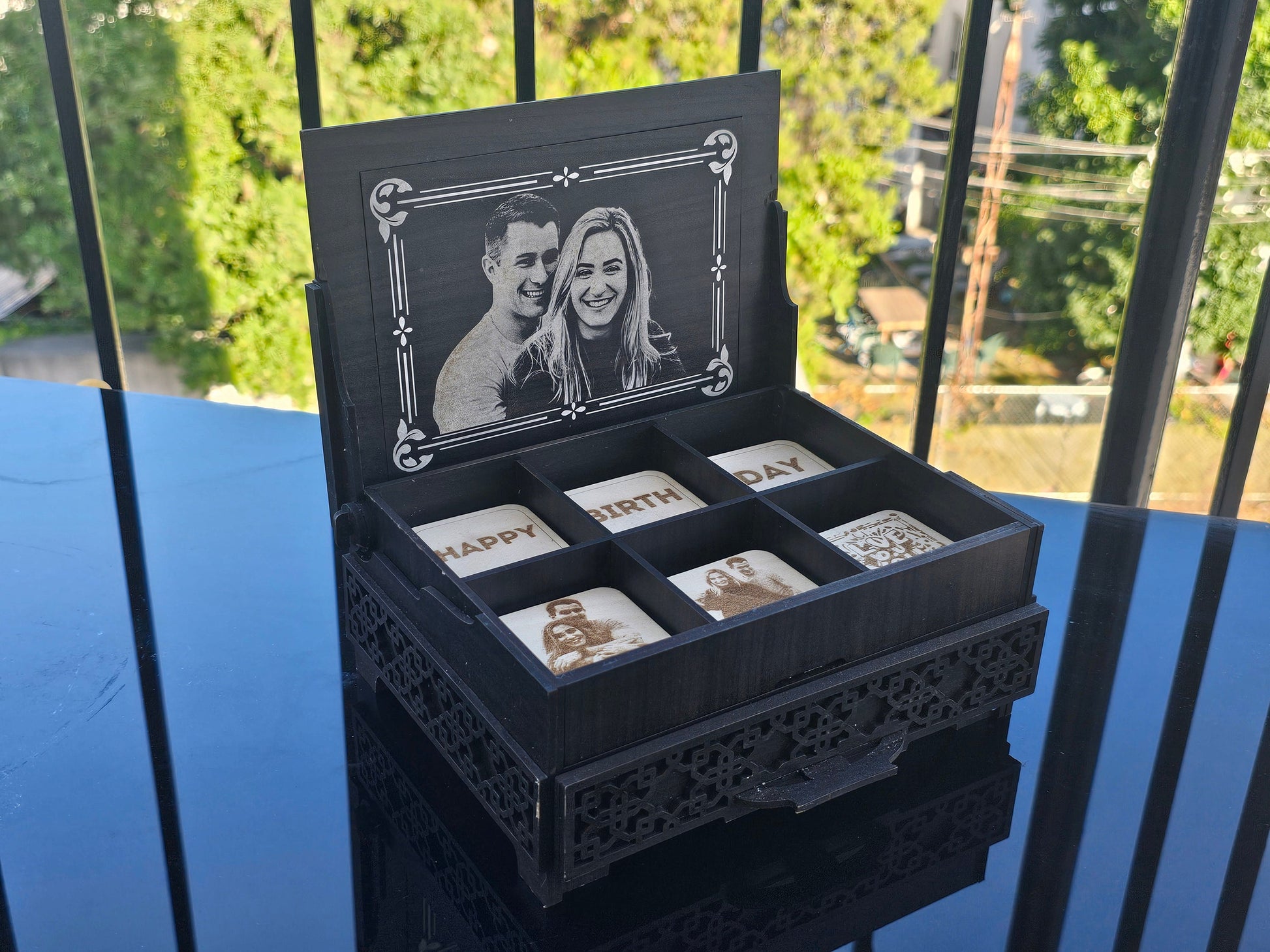 Open personalized chocolate box showing 6 engraved chocolate pieces and a custom photo mosaic in the drawer, engraved on acrylic and wood, ideal for Valentineâ€™s or anniversary gift.