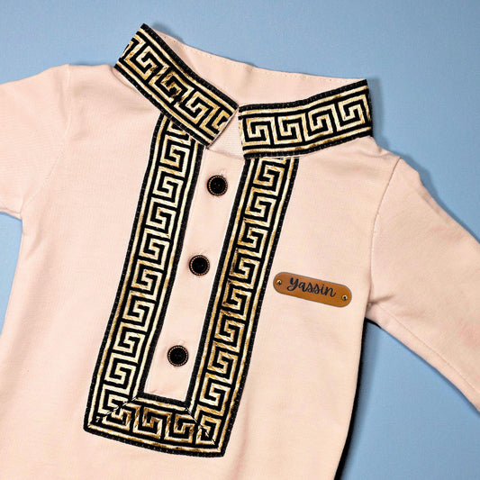 Personalized Ramadan baby jumpsuit in white with gold embroidery and name tag “Yassin”