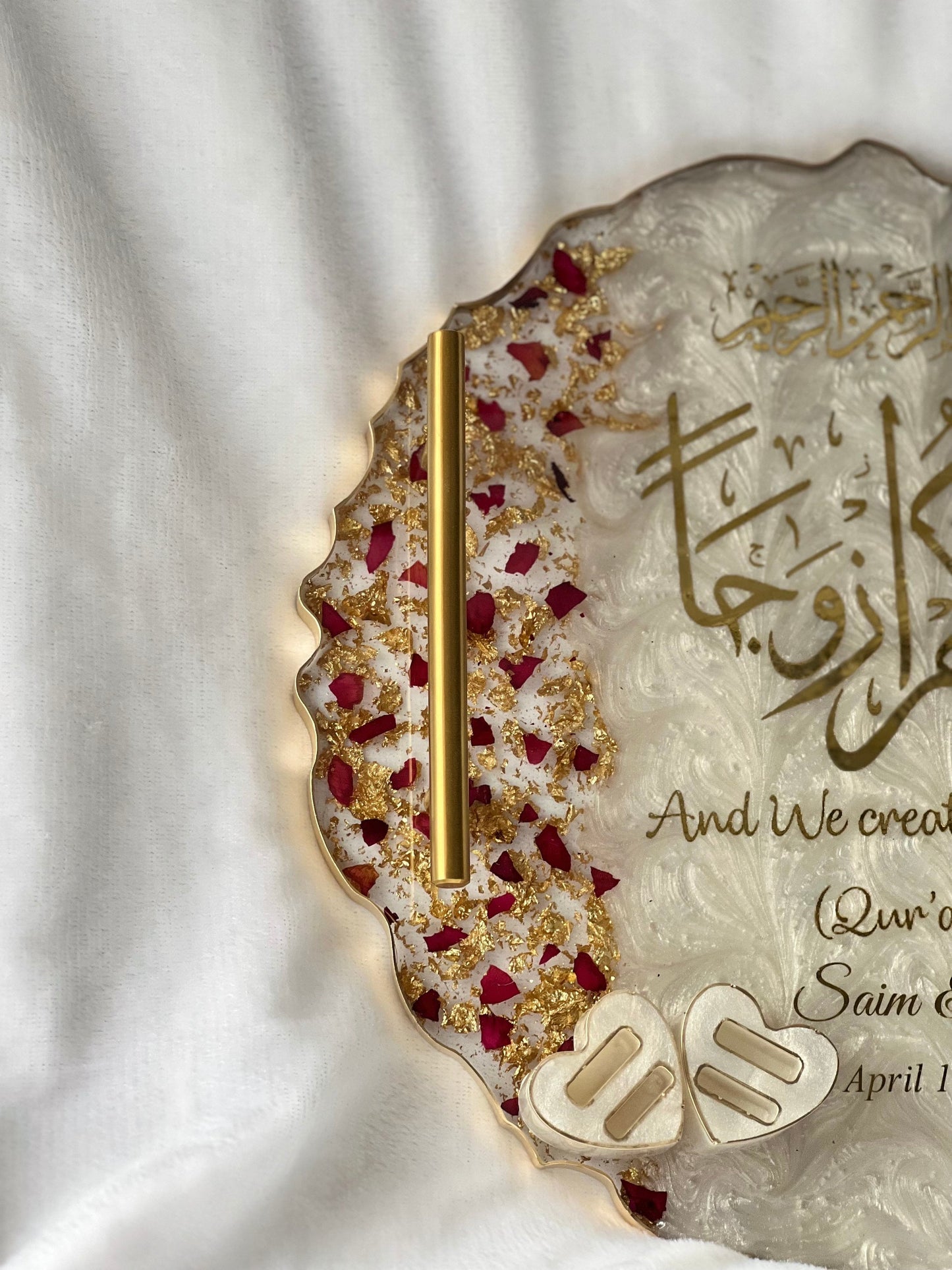 Close-up of engagement tray with engraved names and heart-shaped ring slot, decorated with dried petals and luxury epoxy finish