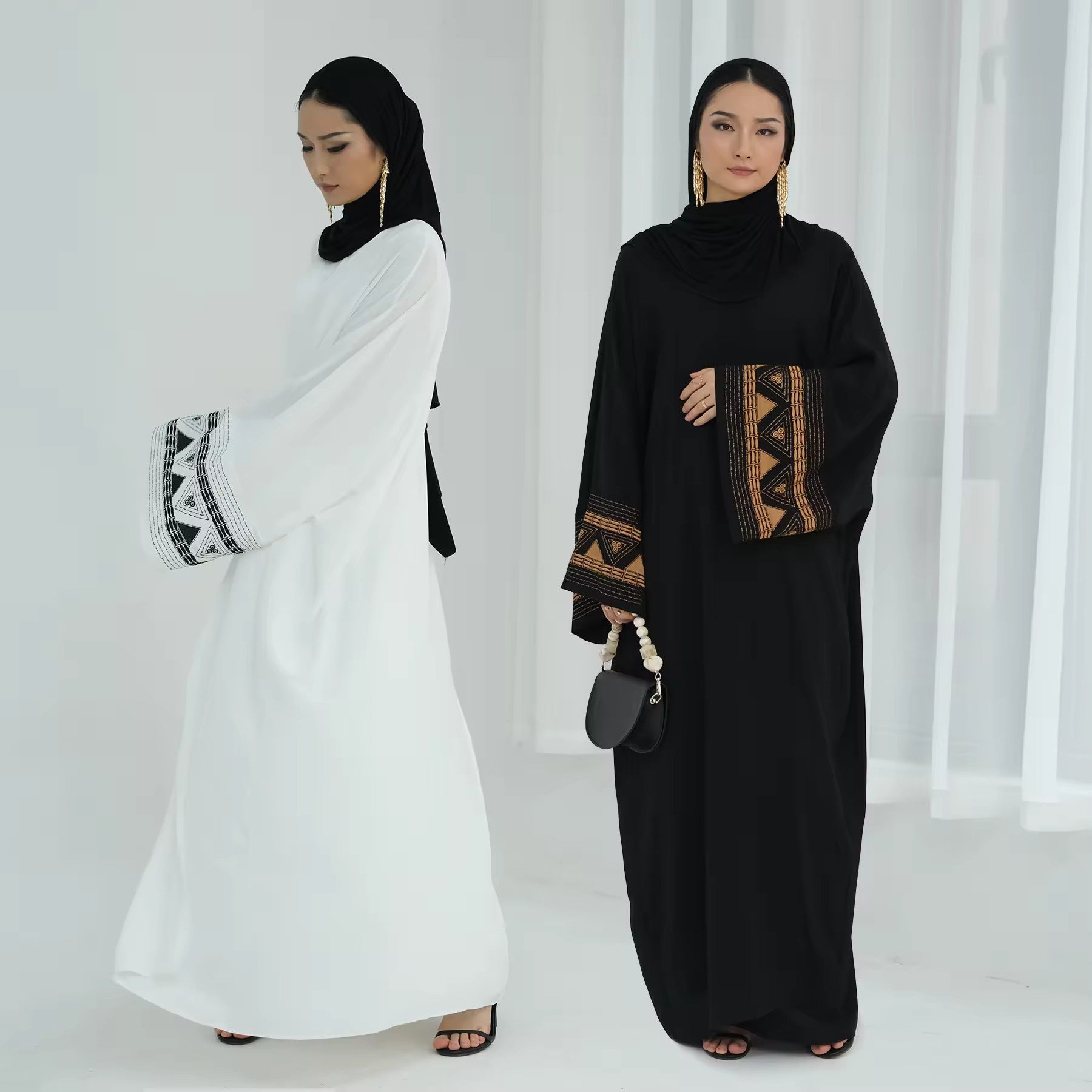 Model wearing black and white abaya – modest outfit for hijabi women
Elegant embroidered abaya for Muslim women – white and black kaftan with wide sleeves – modest Islamic clothing