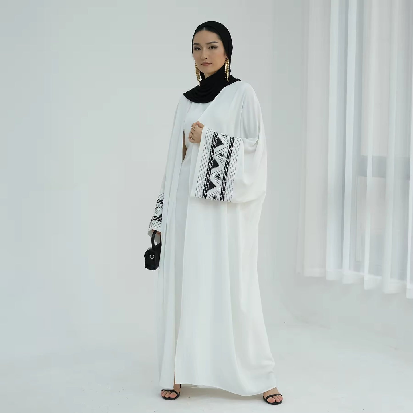 Side view of modern white abaya dress with black embroidery – Ramadan/Eid outfit for Muslim women