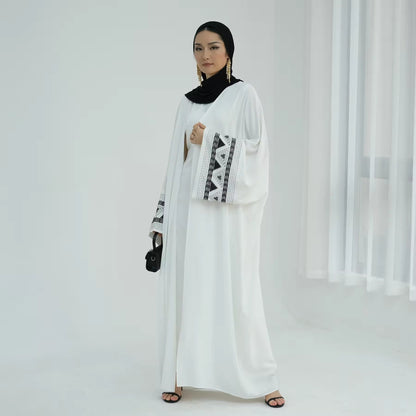 Side view of modern white abaya dress with black embroidery – Ramadan/Eid outfit for Muslim women